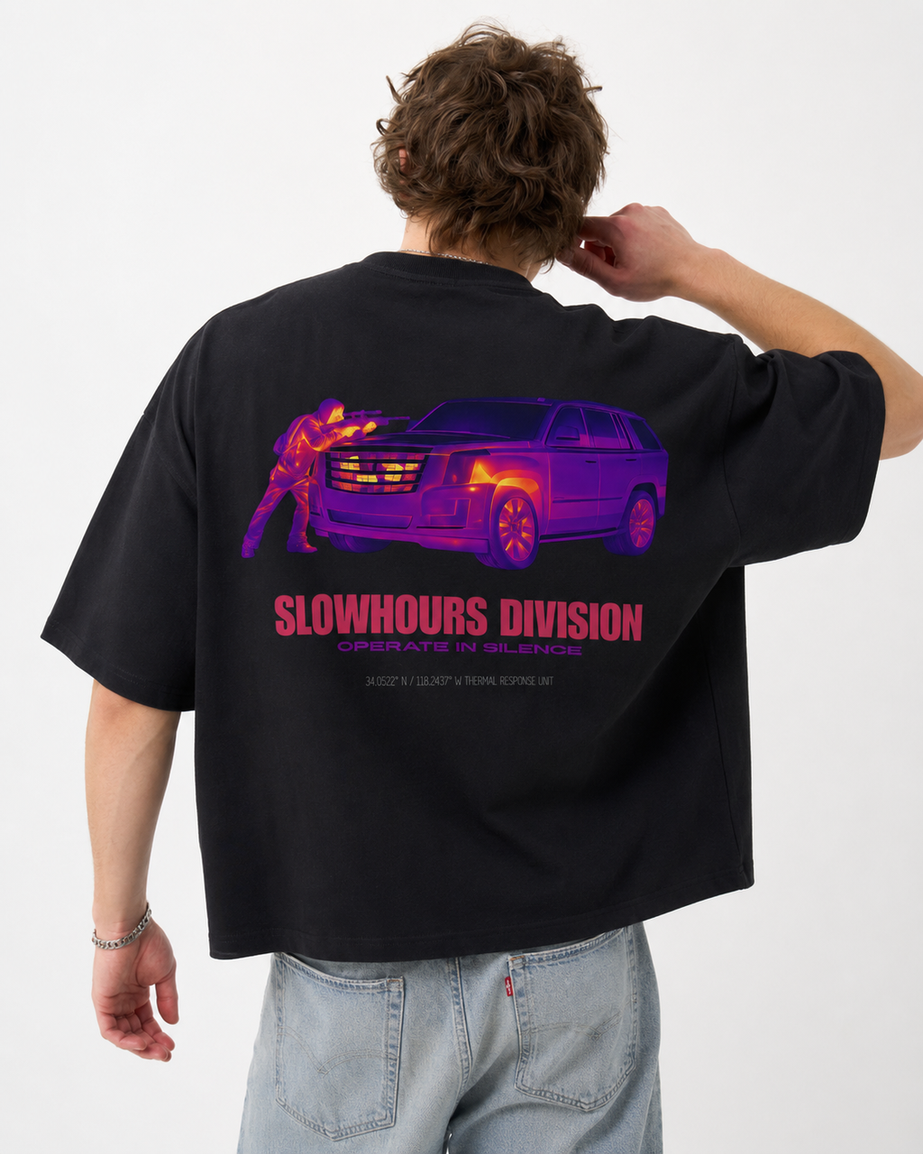 Person wearing a black t-shirt with a graphic design and text on the back, on a white background